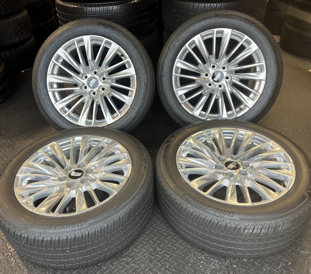 OEM 22” Polished Aluminum Wheels wrapped in Bridgestone tires.