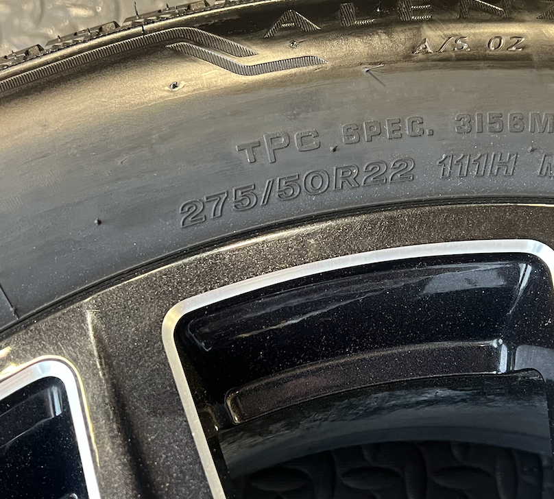 OEM 22” Gloss Black Machined Wheels wrapped in Bridgestone tires.