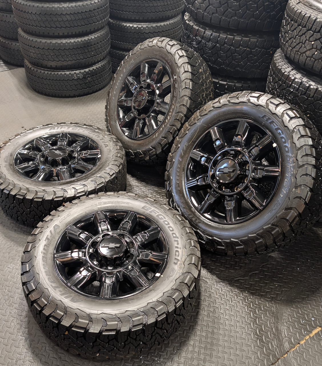 OEM 20” Gloss Black Chevrolet Silverado 2500HD / 3500HD Wheels wrapped in BFGoodrich All-Terrain T/A KO3 tires.