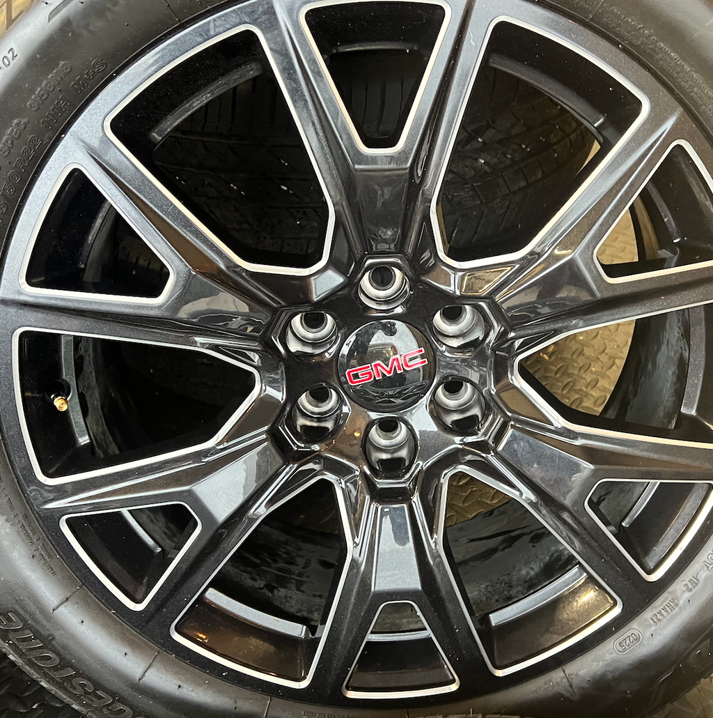 OEM 22” Gloss Black Machined Wheels wrapped in Bridgestone tires.