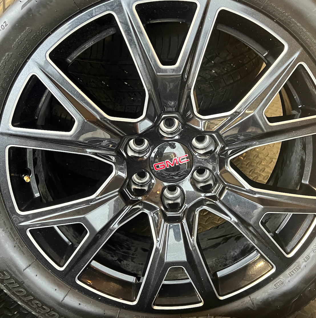 OEM 22” Gloss Black Machined Wheels wrapped in Bridgestone tires.