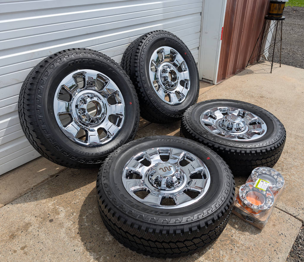 OEM 20” Chrome Ford F-250 / F-350 Wheels wrapped in Bridgestone Dueler A/T tires.