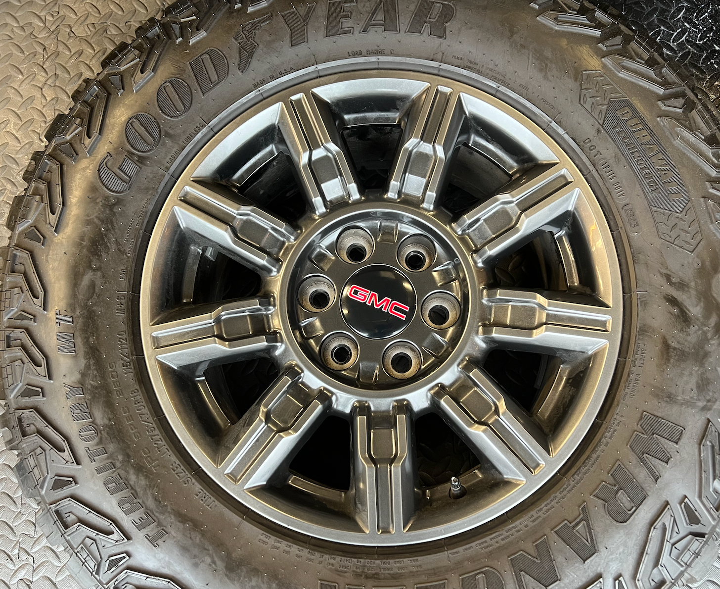 OEM 18" at4x machined aluminum Wheels wrapped in Goodyear tires.