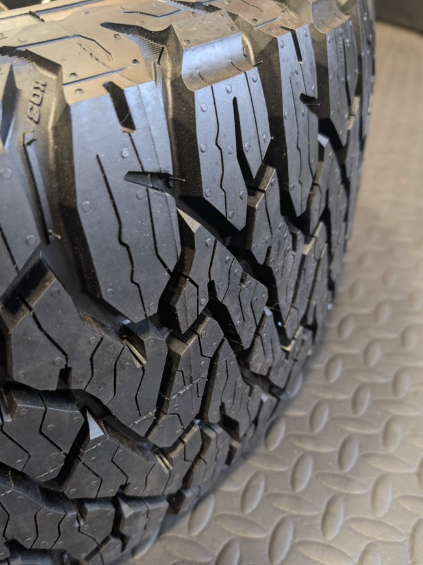 OEM 22” Gloss Black GMC Sierra 2500HD / 3500HD Wheels wrapped in BFGoodrich All-Terrain T/A KO2/KO3 tires.
