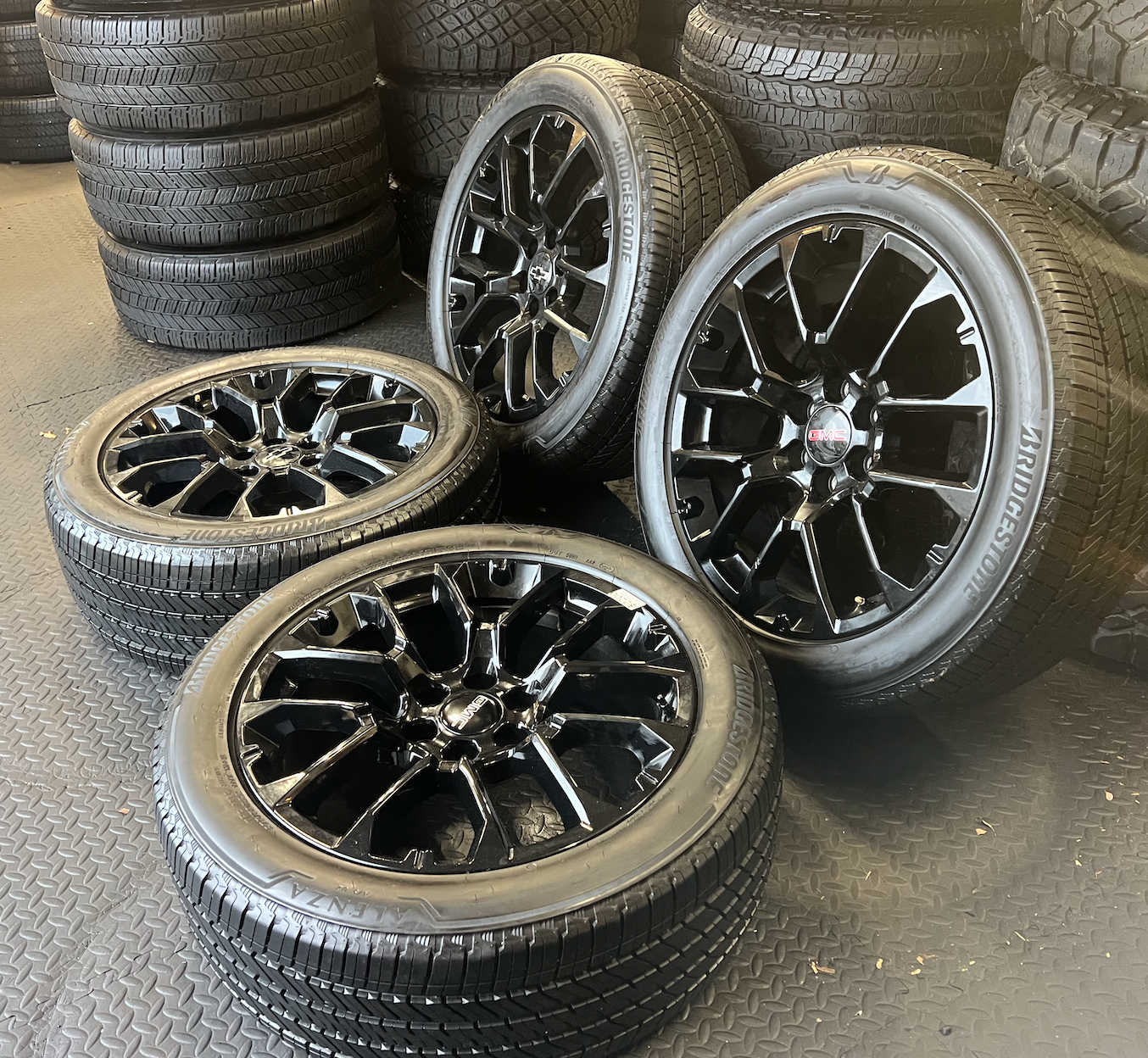 OEM 22” Gloss Black Replica Wheels wrapped in Bridgestone tires.