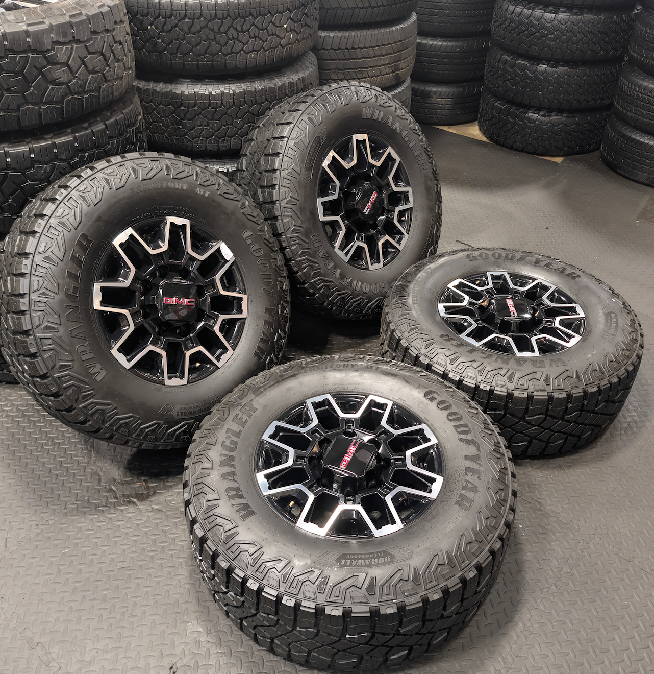 OEM 18” GMC Sierra 2500HD AT4X Black Wheels wrapped in Goodyear Wrangler Territory M/T tires.
