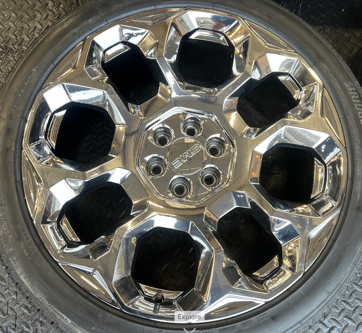 OEM 24” Chrome GMC Wheels wrapped in Bridgestone tires.
