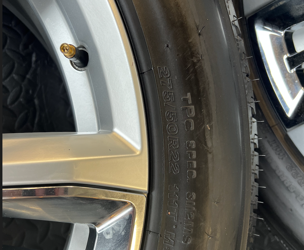 OEM 22” Chevrolet High Country Wheels wrapped in Bridgestone tires.