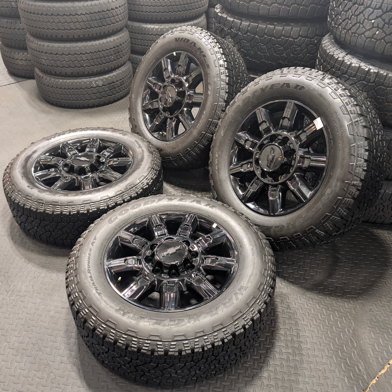 OEM 20” Gloss Black Chevrolet Silverado / GMC Sierra 2500HD & 3500HD Wheels wrapped in LT275/65R20 Goodyear Wrangler TrailRunner A/T tires.
