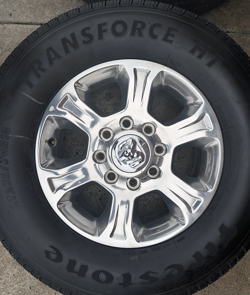 Polished Aluminum Ram 2500 / 3500 OEM 18” Wrapped in Firestone Transforce HT LT275/70R18