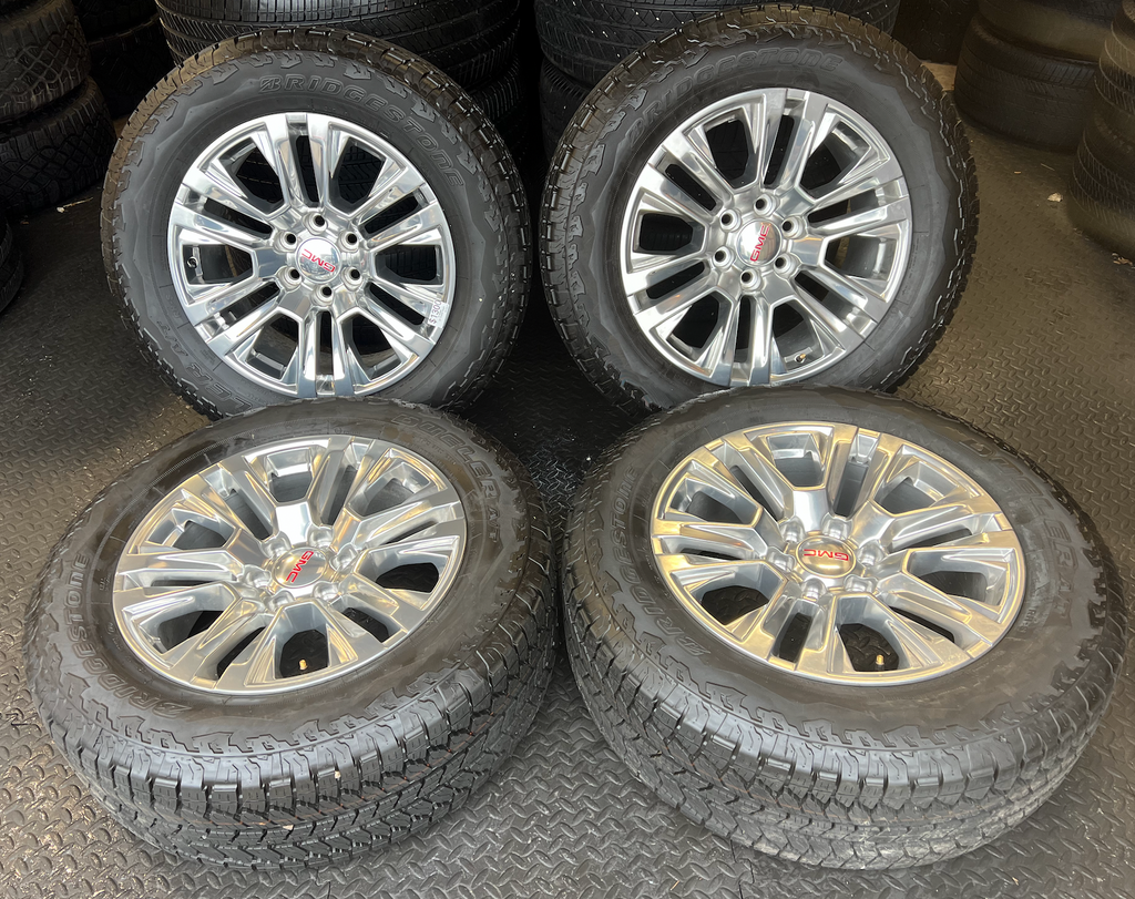 OEM Rebuilt 20” Polished Wheels wrapped in Bridgestone Dueler tires.
