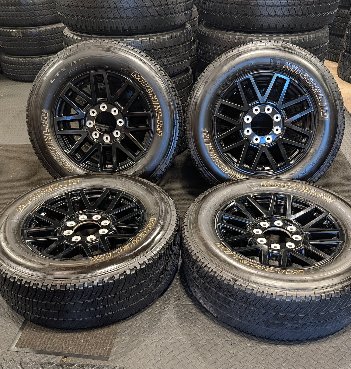 OEM 20” Gloss Black Ford F-250 / F-350 Wheels wrapped in Michelin LTX tires.