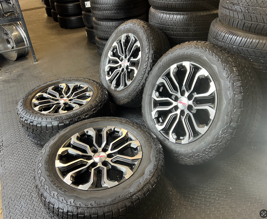 OEM 20” Charcoal Machined Wheels wrapped in Bridgestone Dueler A/T tires.