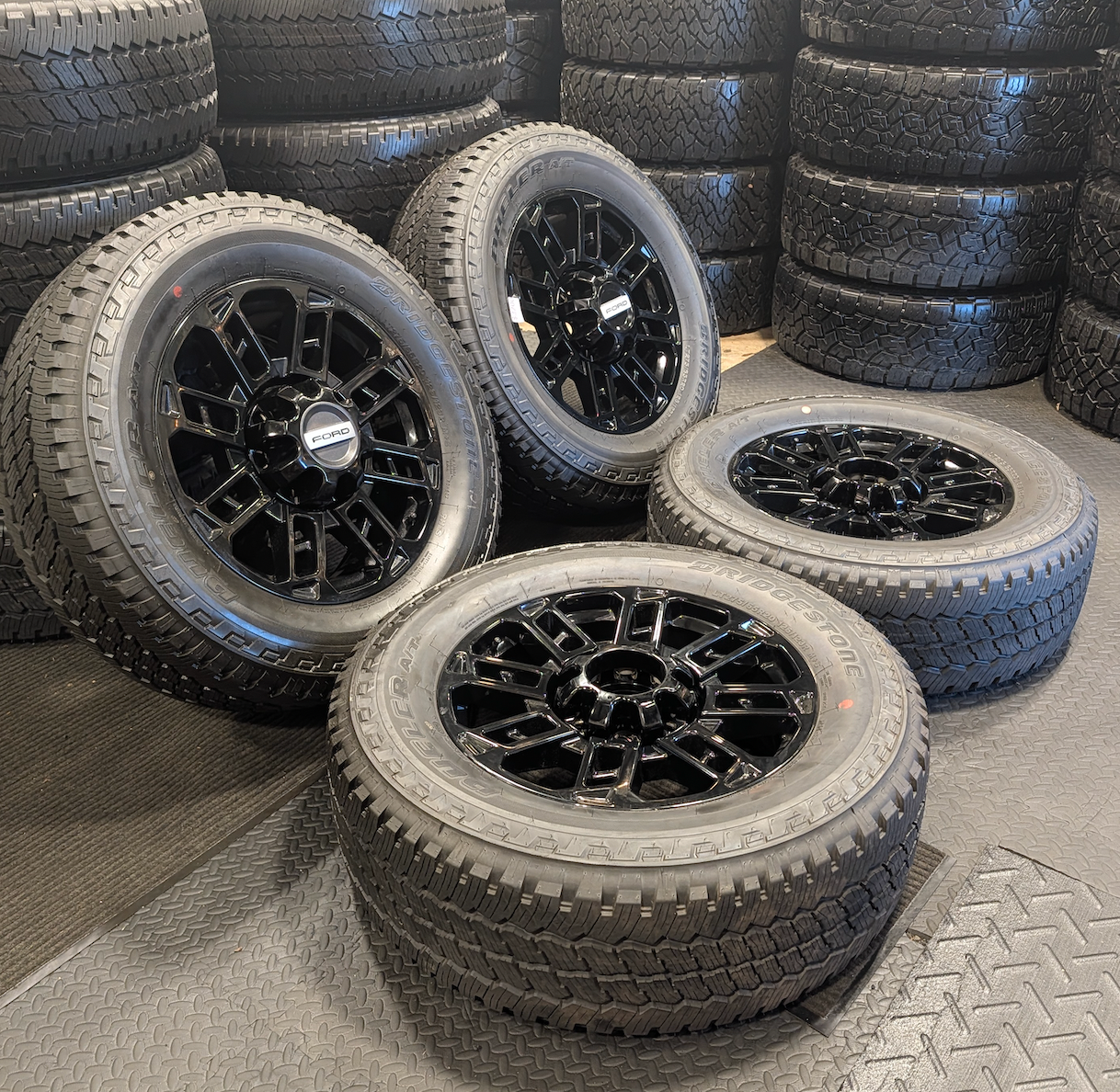 OEM 20” Gloss Black Ford F-250 / F-350 Wheels wrapped in Bridgestone Dueler A/T tires.