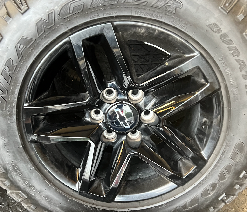 OEM 18” Gloss Black Trail Boss Wheels wrapped in Goodyear Wrangler Duratrac tires.