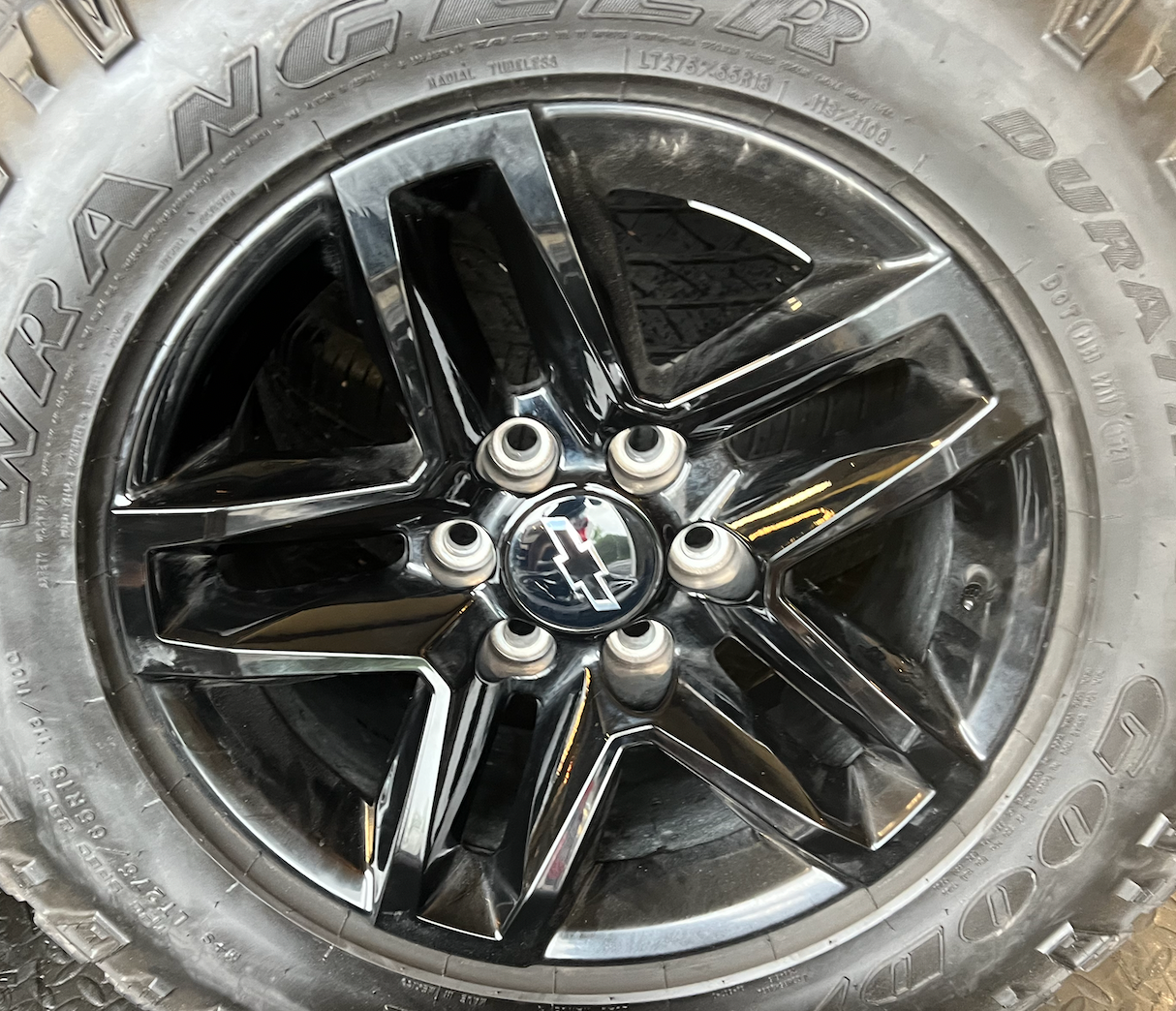 OEM 18” Gloss Black Trail Boss Wheels wrapped in Goodyear Wrangler Duratrac tires.