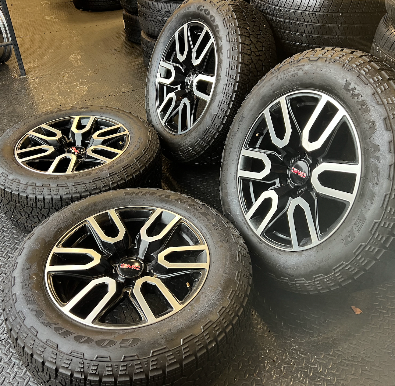 OEM 20” Gloss Black Wheels with Silver Inserts / Accents wrapped in Goodyear Wrangler TrailRunner A/T tires.