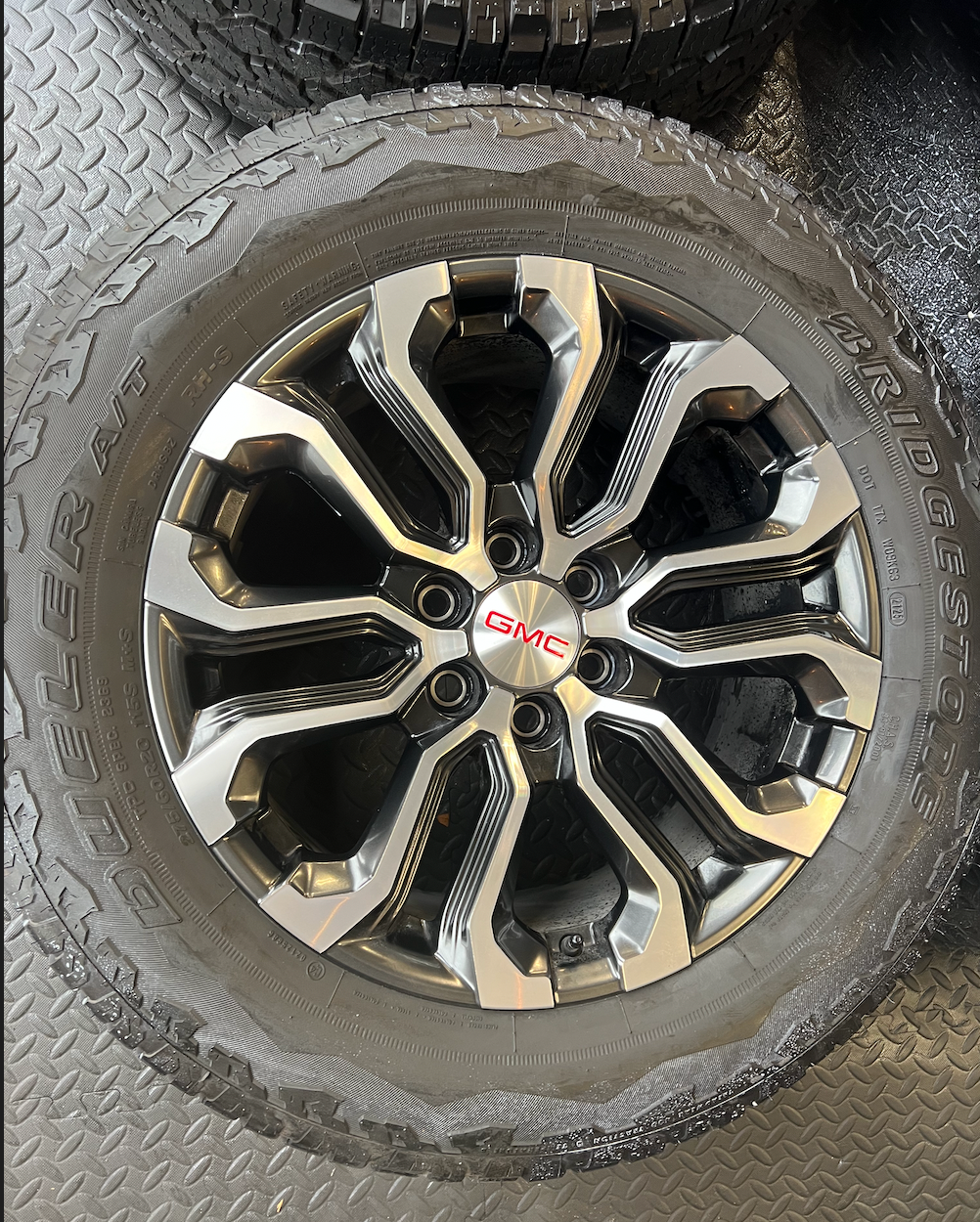 OEM 20” Charcoal Machined Wheels wrapped in Bridgestone Dueler A/T tires.
