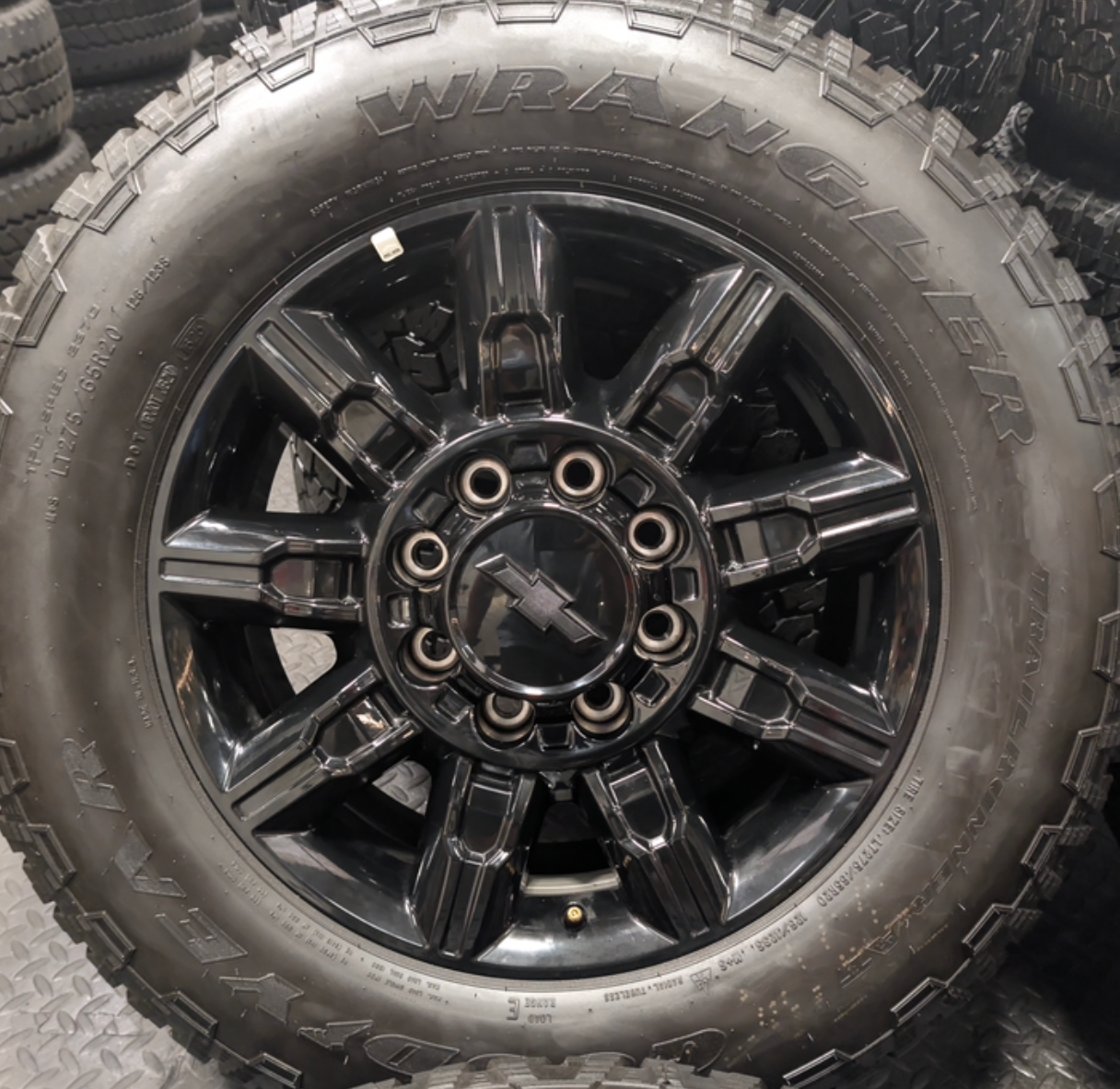 OEM 20” Gloss Black Chevrolet Silverado / GMC Sierra 2500HD & 3500HD Wheels wrapped in LT275/65R20 Goodyear Wrangler TrailRunner A/T tires.