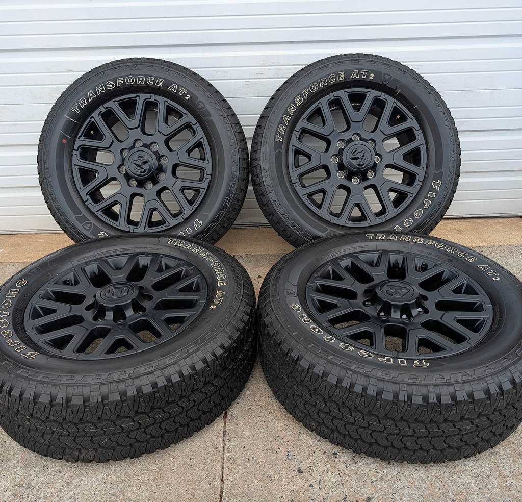 Matte Black Ram 2500 / 3500 OEM 20” Wrapped in Firestone Transforce AT2 LT285/60R20