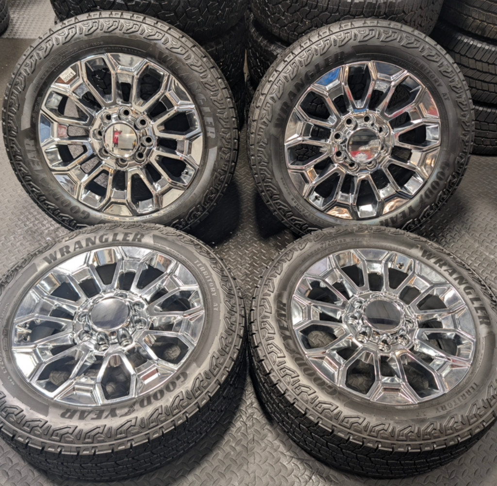 OEM 22” Chrome Chevrolet Silverado 2500HD / 3500HD & GMC Sierra 2500HD / 3500HD Wheels wrapped in Goodyear Wrangler Territory A/T tires.