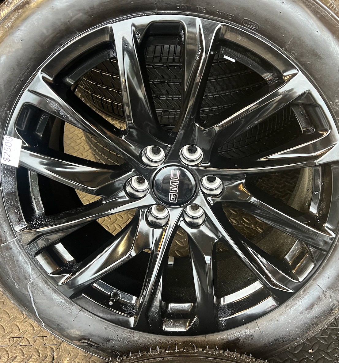 OEM 22” Gloss Black Wheels wrapped in Bridgestone tires.