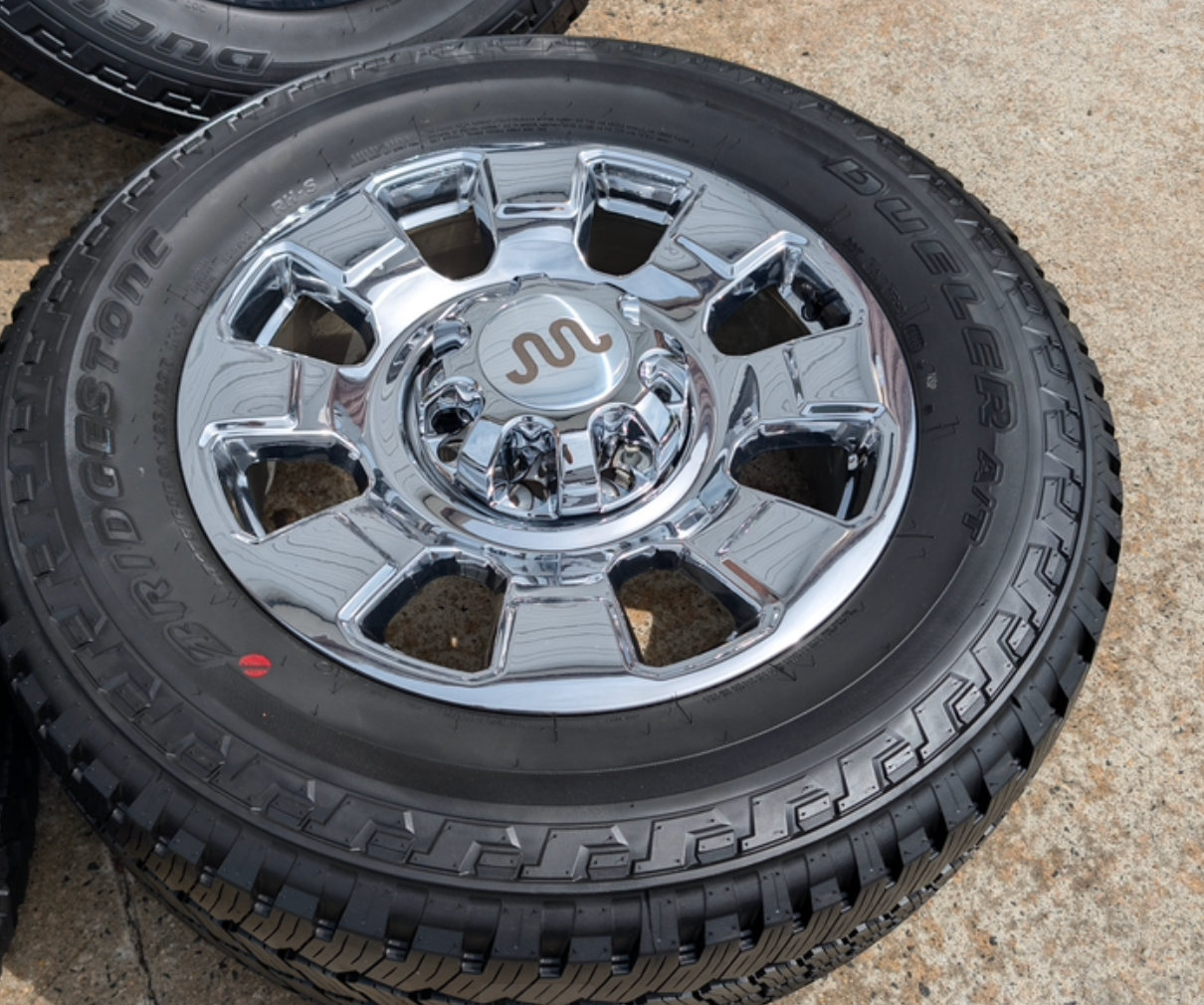 OEM 20” Chrome Ford F-250 / F-350 Wheels wrapped in Bridgestone Dueler A/T tires.