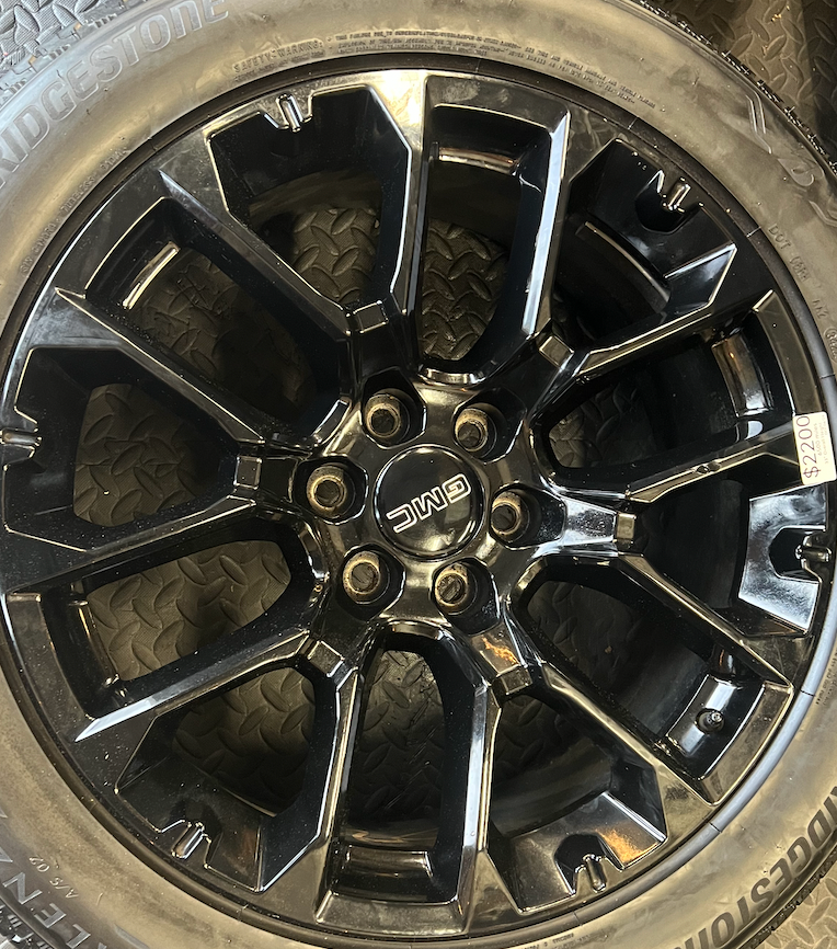 OEM 22” Gloss Black Replica Wheels wrapped in Bridgestone tires.