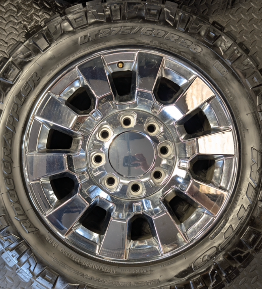 OEM 20” Chrome GMC Sierra Denali 2500HD / 3500HD Wheels wrapped in LT275/60R20 Nitto Ridge Grappler tires.