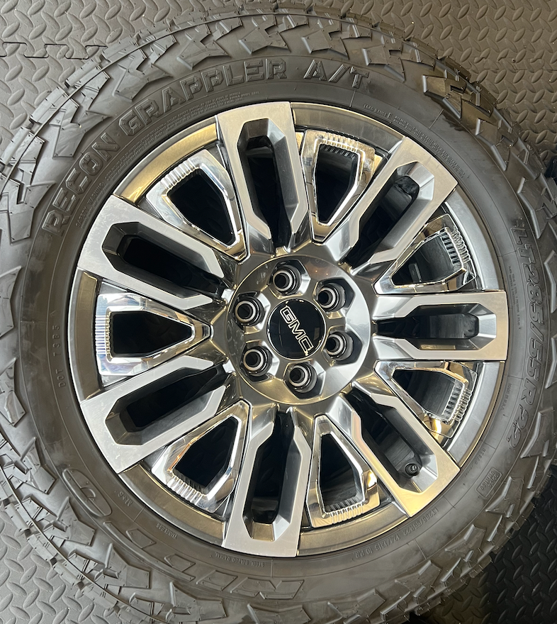 OEM 22”  Denali Ultimate Wheels with Charcoal Machined Finish & Chrome Inserts wrapped in Nitto Recon Grappler A/T tires.