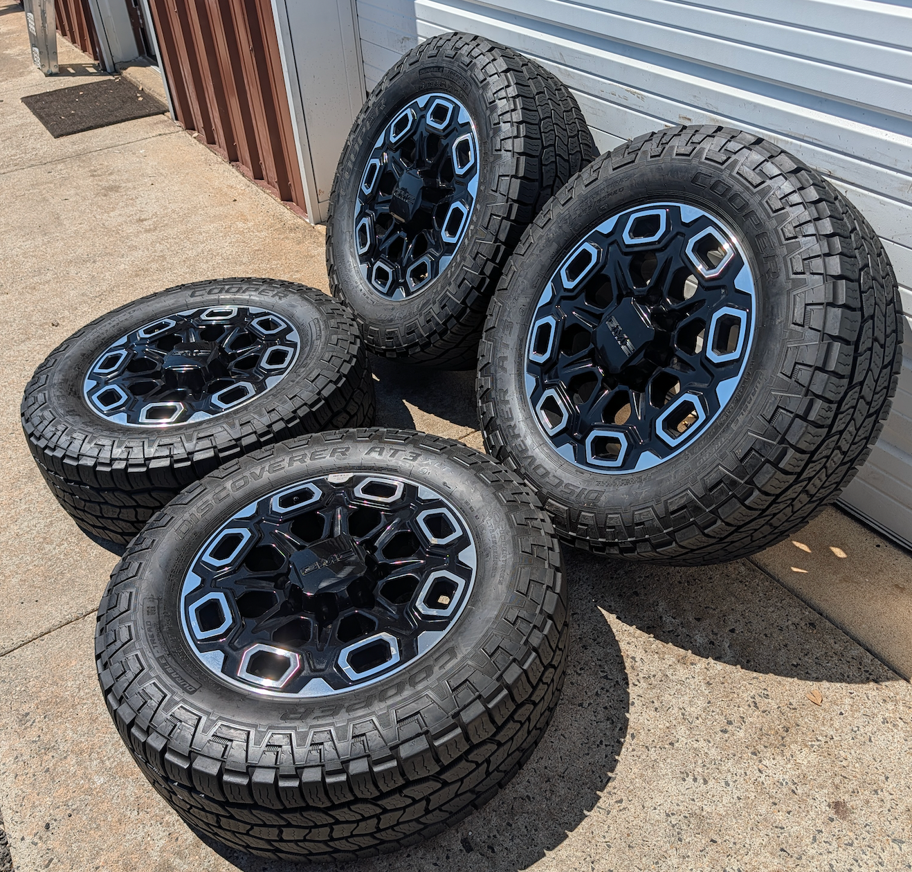 OEM 20” Machined Black GMC Sierra 2500HD / 3500HD Wheels wrapped in Cooper Discoverer AT3 tires.