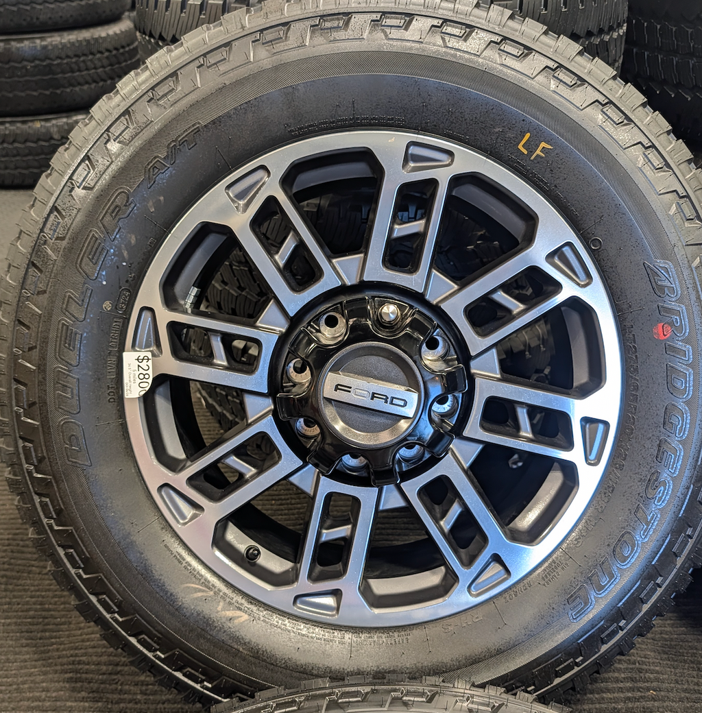 OEM 20” Ford Limited / Platinum Wheels wrapped in Bridgestone Dueler tires.