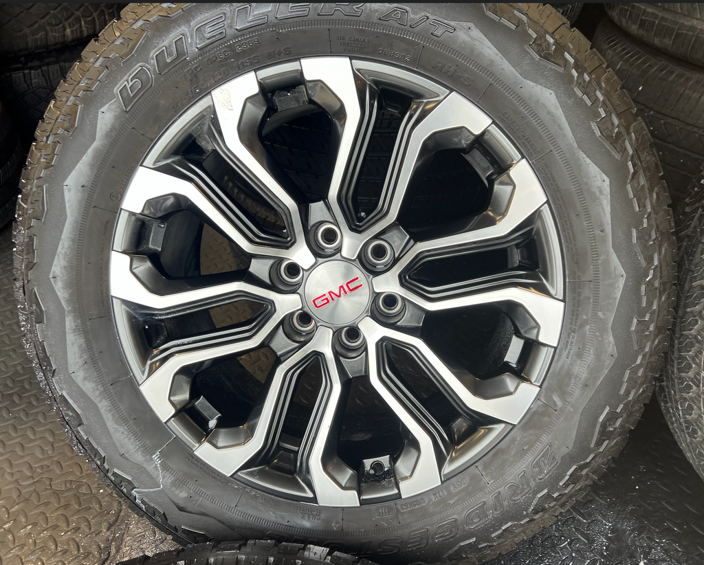 OEM 20” Charcoal Machined Wheels wrapped in Bridgestone Dueler A/T tires.