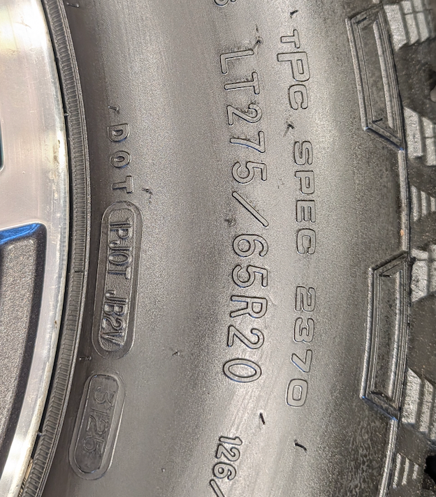 OEM 20” Machined Aluminum Ford F-250 / F-350 Super Duty Wheels wrapped in Goodyear Wrangler TrailRunner A/T tires.