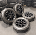 OEM 20” Gloss Black Chevrolet Silverado / GMC Sierra 2500HD & 3500HD Wheels wrapped in LT275/65R20 Goodyear Wrangler TrailRunner A/T tires.