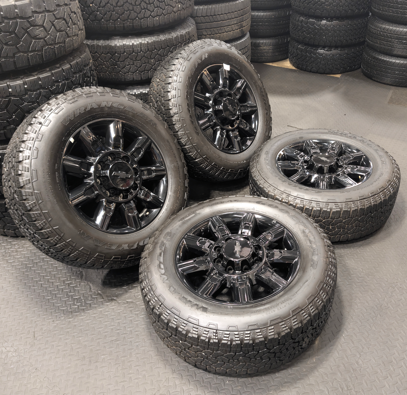 OEM 20” Gloss Black Chevrolet Silverado / GMC Sierra 2500HD & 3500HD Wheels wrapped in LT275/65R20 Goodyear Wrangler TrailRunner A/T tires.