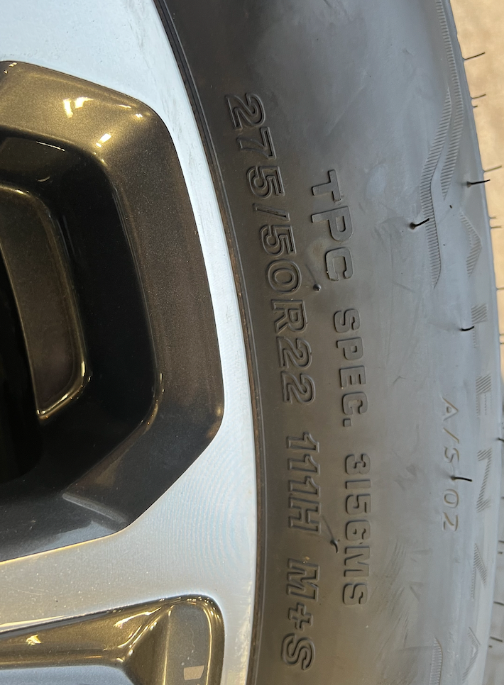 OEM 22” Machined Silver Denali Wheels wrapped in Bridgestone tires.