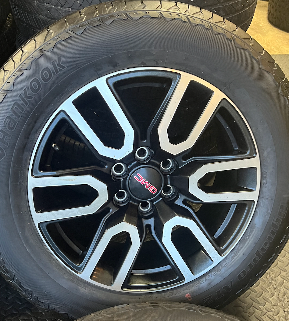 OEM 20” Gloss Black Wheels with Silver Inserts / Accents wrapped in Hankook Dynapro AT2 tires.