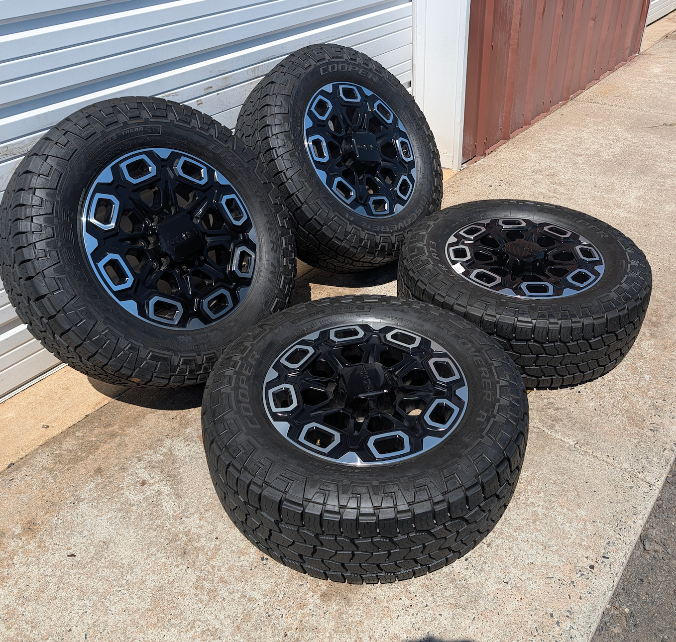 OEM 20” Machined Black GMC Sierra 2500HD / 3500HD Wheels wrapped in Cooper Discoverer AT3 tires.