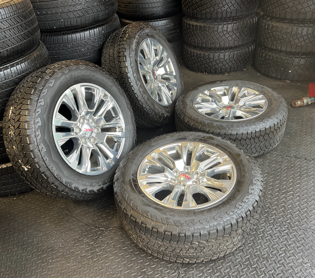 OEM Rebuilt 20” Polished Wheels wrapped in Bridgestone Dueler tires.