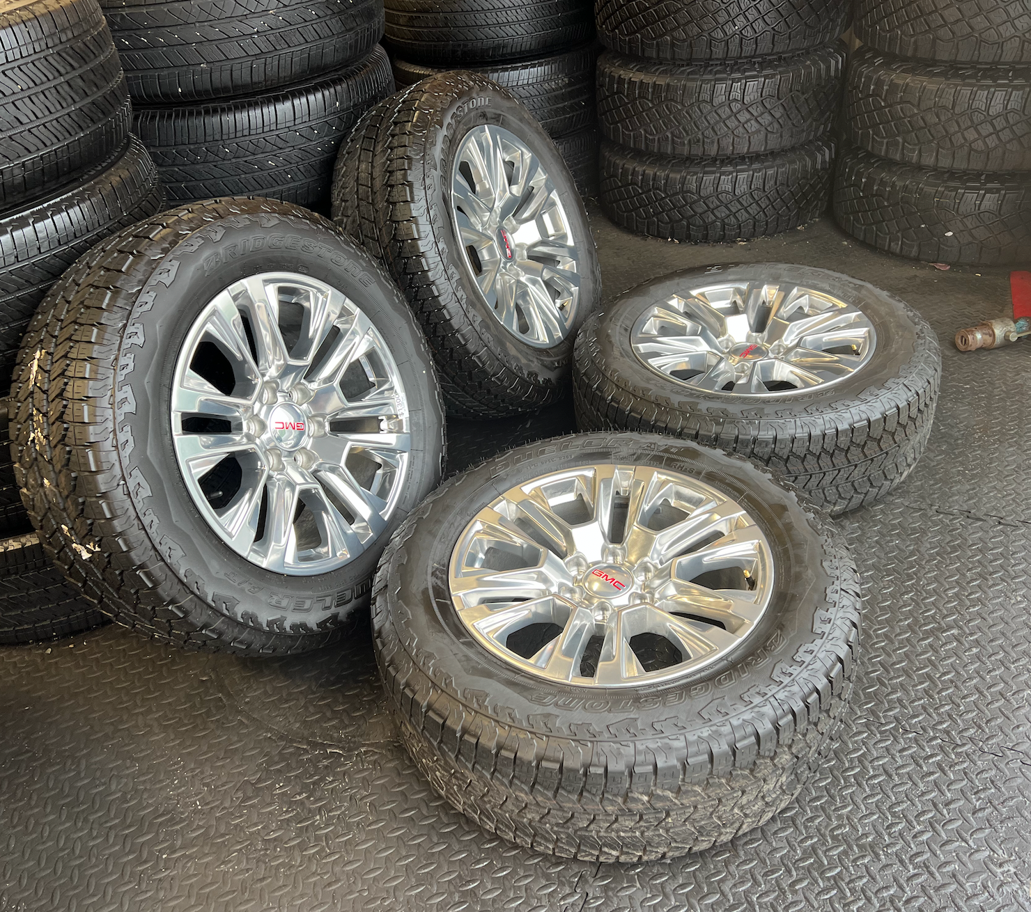 OEM Rebuilt 20” Polished Wheels wrapped in Bridgestone Dueler tires.