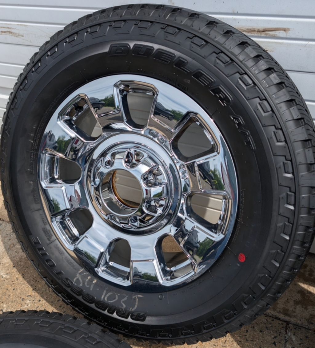 OEM 20” Chrome Ford F-250 / F-350 Wheels wrapped in Bridgestone Dueler A/T tires.