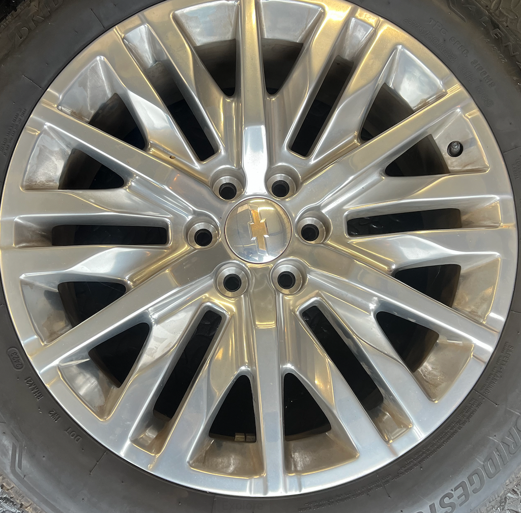 OEM 22” Polished 6-Split-Spoke Chevrolet Wheels wrapped in Bridgestone tires.
