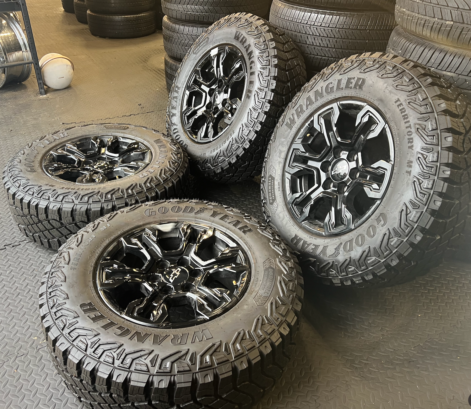 OEM 18” Gloss Black Chevrolet Silverado ZR2 Wheels wrapped in LT275/70R18 Goodyear Wrangler Territory MT tires.