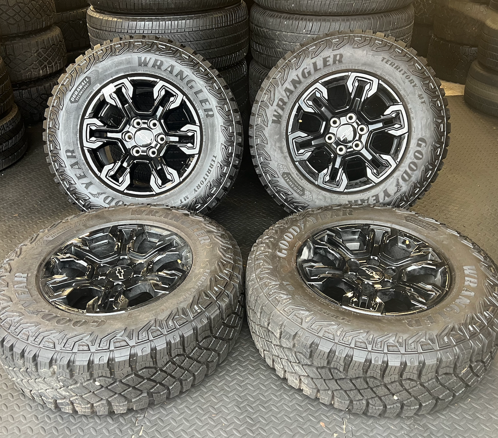 OEM 18” Gloss Black Chevrolet Silverado ZR2 Wheels wrapped in LT275/70R18 Goodyear Wrangler Territory MT tires.