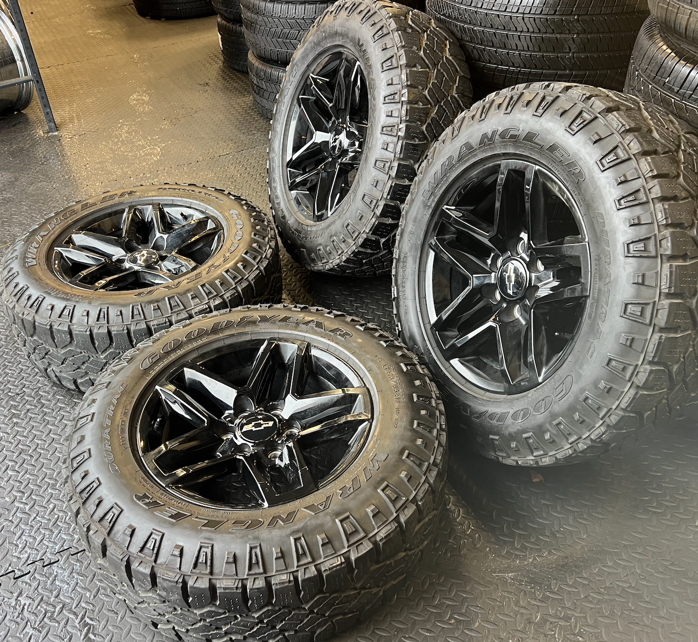 OEM 18” Gloss Black Trail Boss Wheels wrapped in Goodyear Wrangler Duratrac tires.