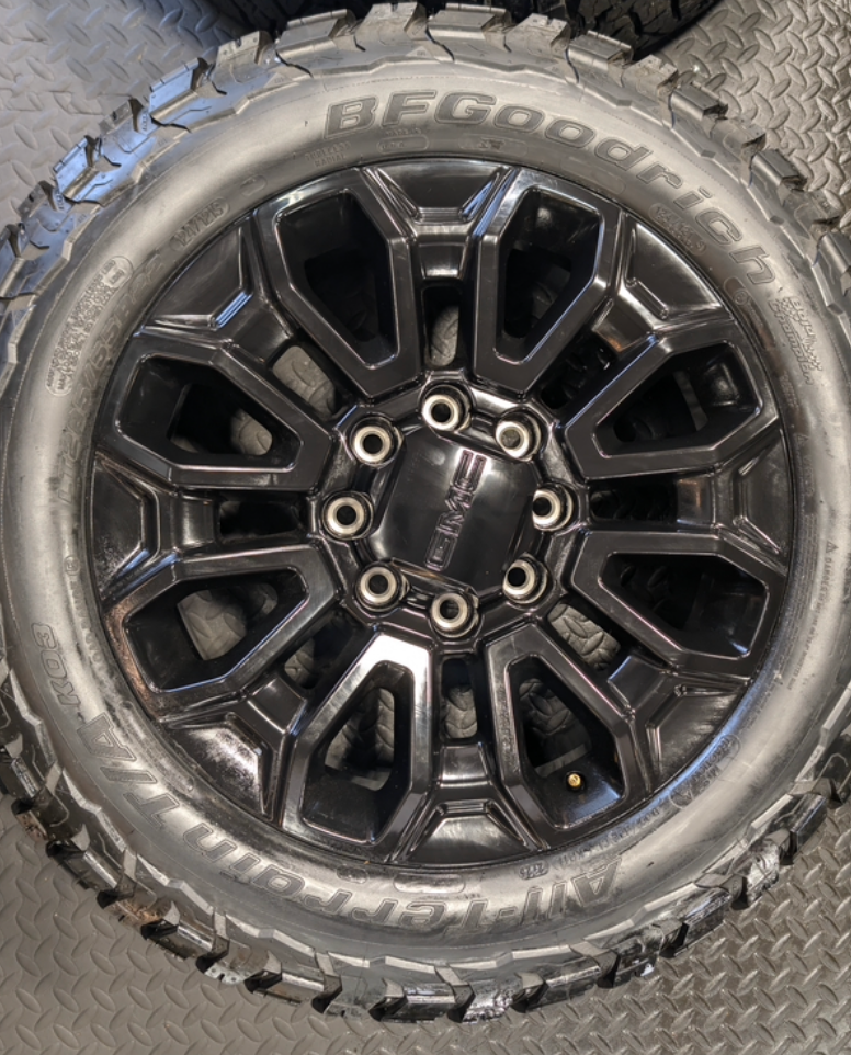 OEM 22” Gloss Black GMC Sierra 2500HD / 3500HD Wheels wrapped in BFGoodrich All-Terrain T/A KO2/KO3 tires.