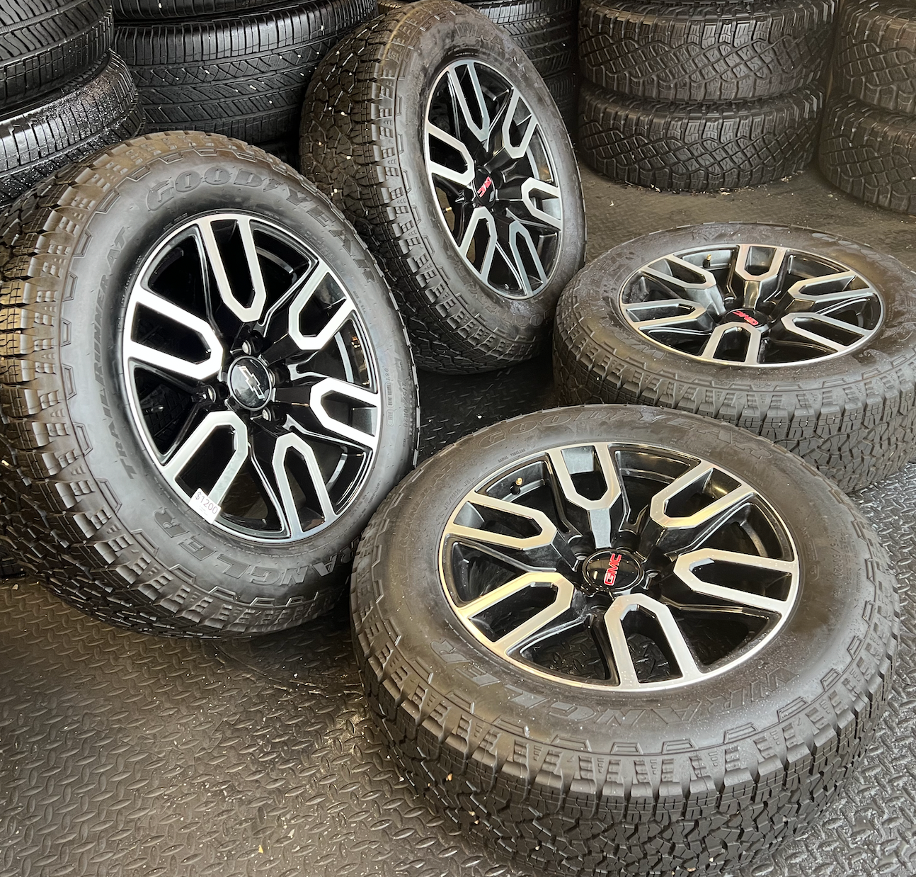 OEM 20” Gloss Black Wheels with Silver Inserts / Accents wrapped in Goodyear Wrangler TrailRunner A/T tires.