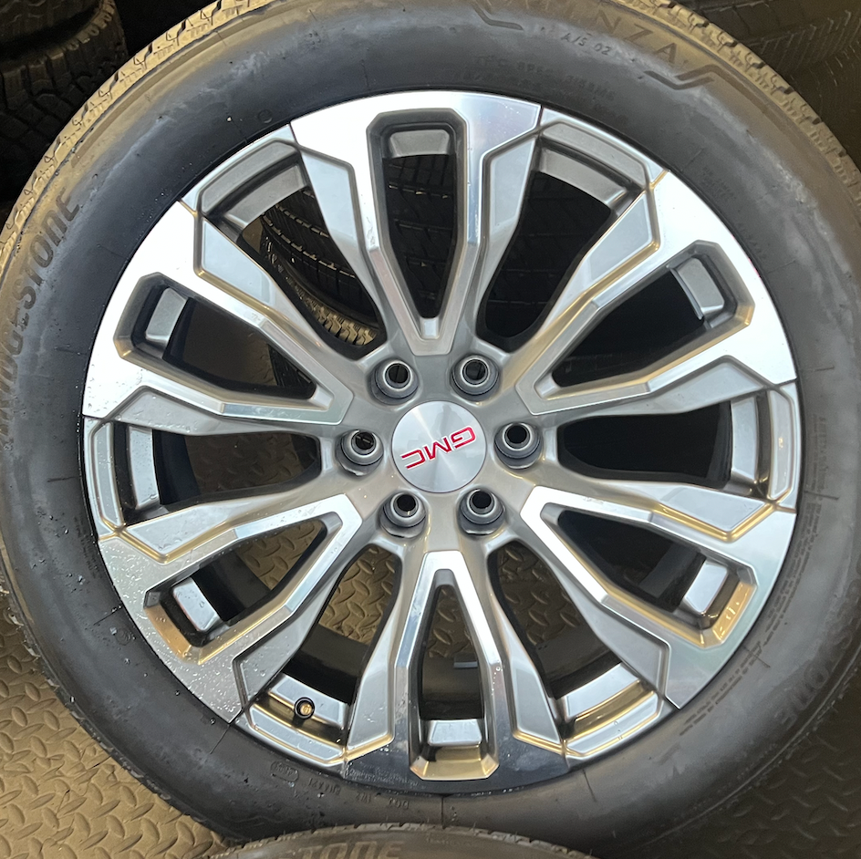 OEM 22” Denali Wheels with Machined & Grey Finish wrapped in Bridgestone tires.