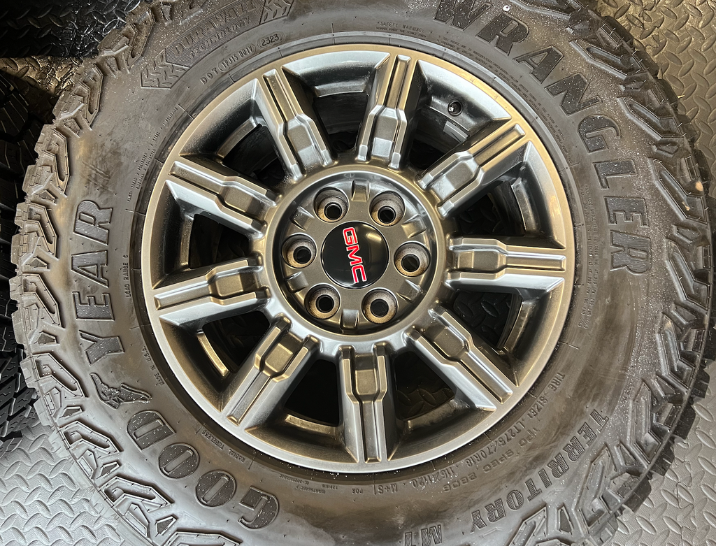 OEM 18" at4x machined aluminum Wheels wrapped in Goodyear tires.